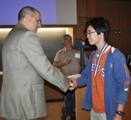 Current Issues and Events State Director Tom Ray congratulates the 5A Champion, Michael Zhu from Dulles HS in Sugarland.