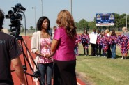 Talking to the local news stations, West Orange-Stark senior Donisha Mosby expresses her thanks for the support that the high school received after Reggie Garrett's death. West Brook High School students hold chains in the background that were made for WO-S to hang on their fences at the home games. 