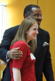 Vice President for DDCE Gregory Vincent congratulates Julianne Coyne after she receives a student excellence award.