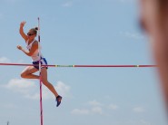 As her coach watches, sophomore Charlotte Brown clears the bar at the UIL State Track Meet. Brown, who is legally blind, placed eighth in the 3A competition.