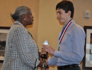 Dr. Aileen T Bumphus, Executive Director of the Gateway Program in the DDCE, presents Roger Cain from LASA his award for winning the state contest.