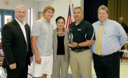 Athletic Director Dr. Mark Cousins (far right) presents the Spirit of Sport Award to the Bastrop High School football team. 